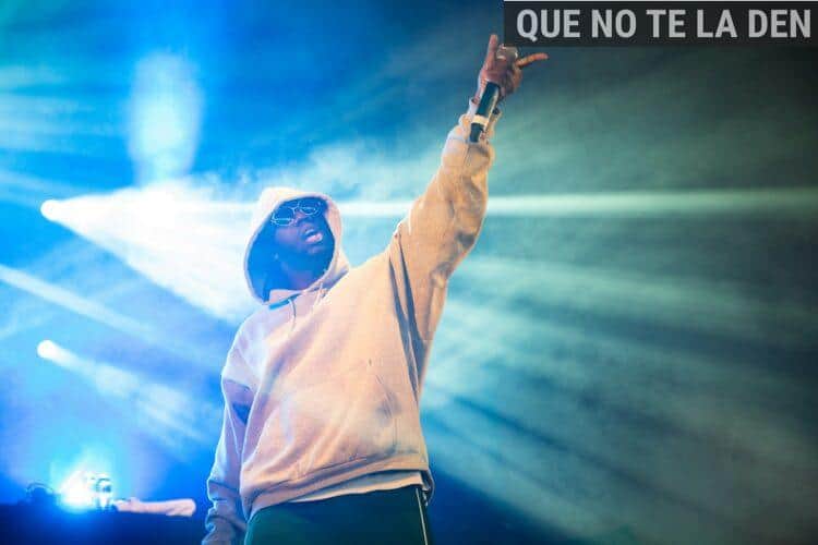 man raising his left hand with microphone
