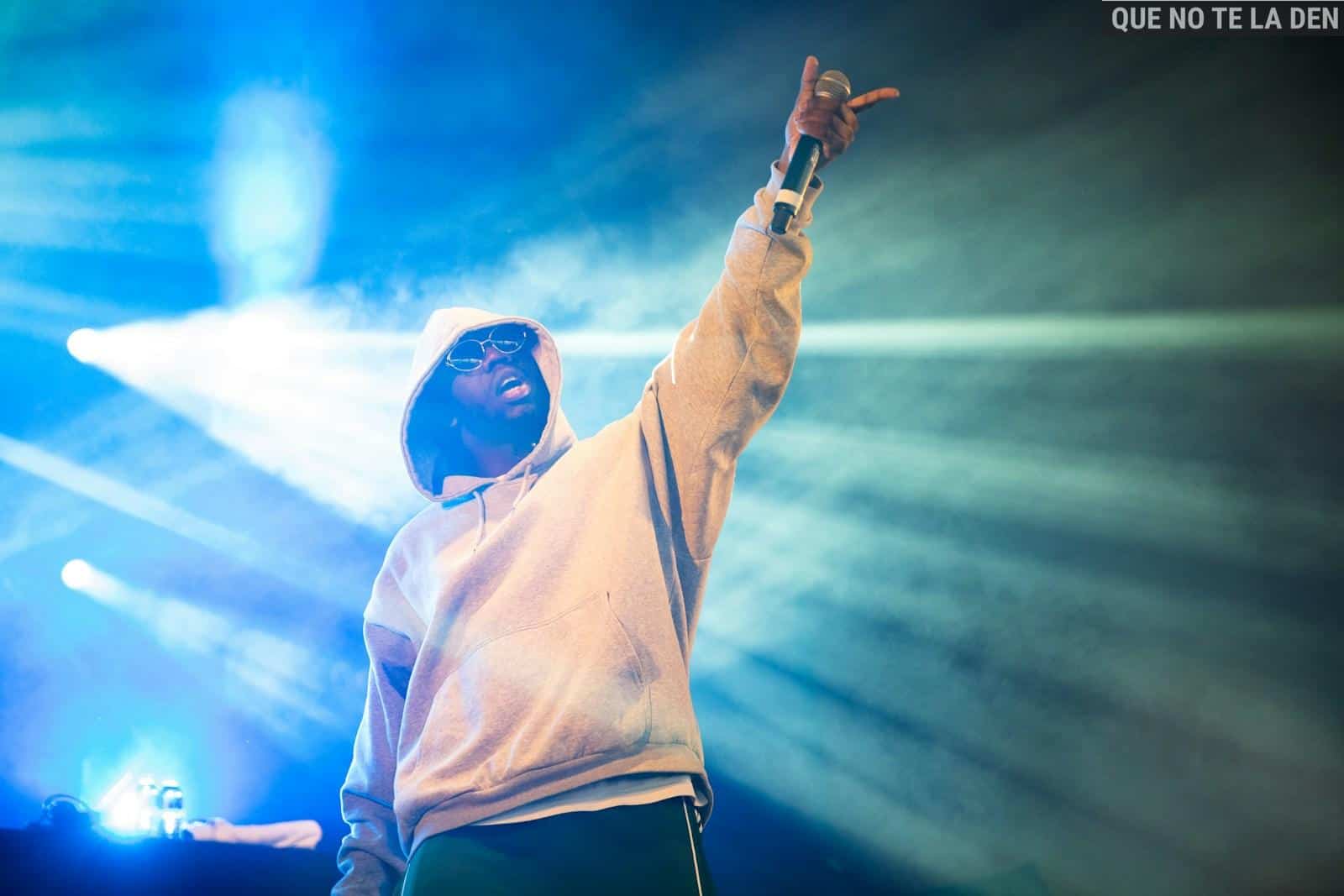 man raising his left hand with microphone