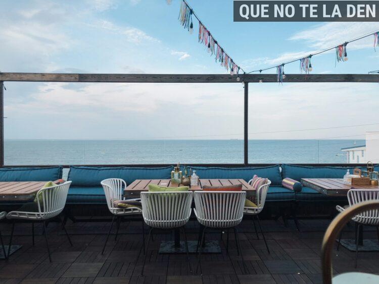 brown wooden table and chairs near swimming pool during daytime